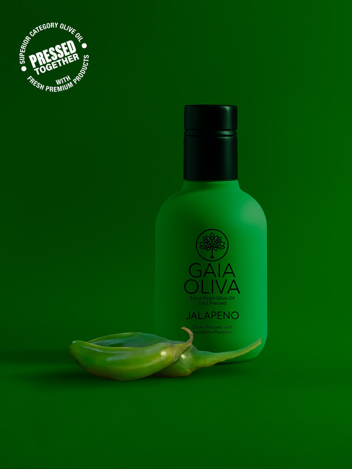 Gaia Oliva bottle of Jalapeño Extra virgin olive oil with fresh Jalapeños