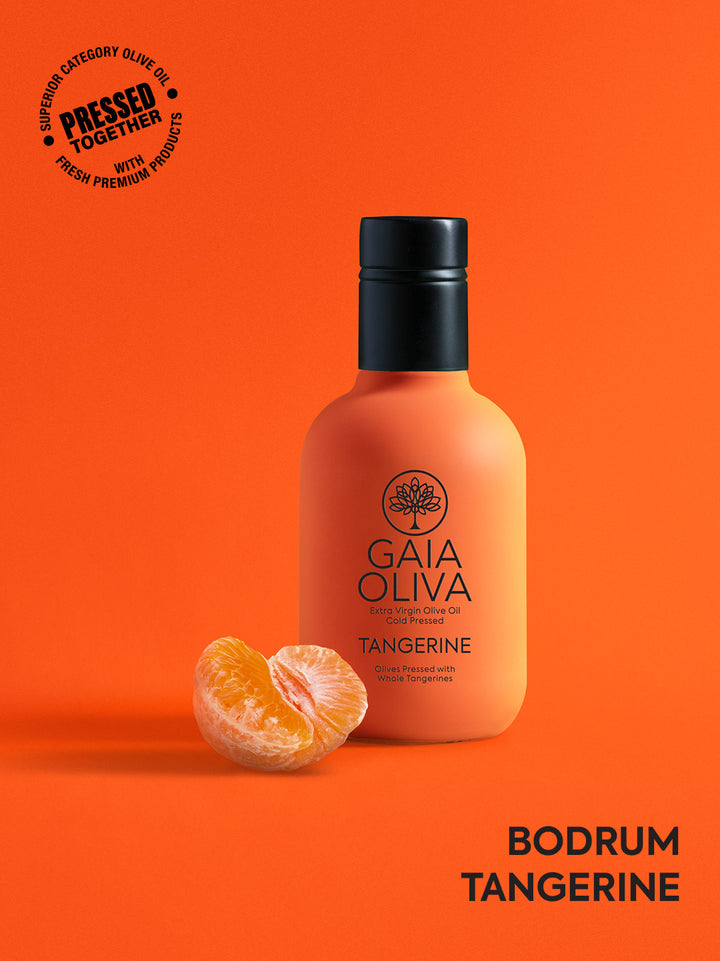 a bottle of tangerine extra virgin olive oil with fresh tangerine