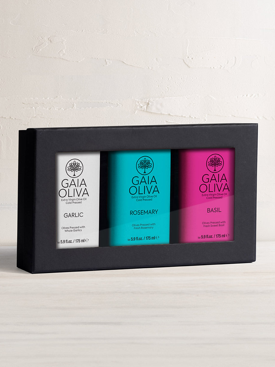 Extra Virgin Olive Oil Gift Set featuring Garlic, Rosemary, and Basil flavored oils in sleek packaging.