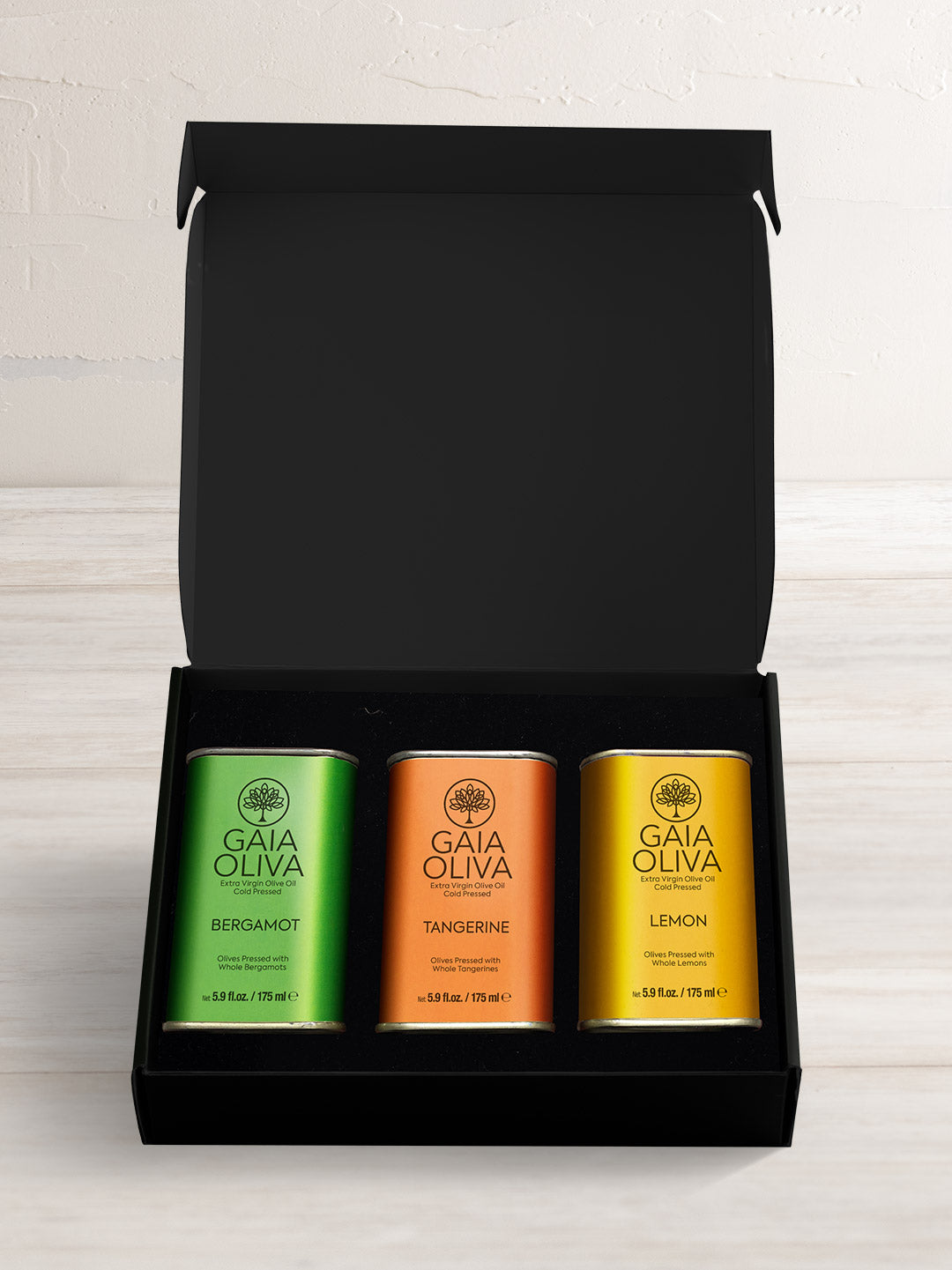 extra virgin olive oil gift set with tangerine, bergamot and lemon olive oil in tins in a black gift box 