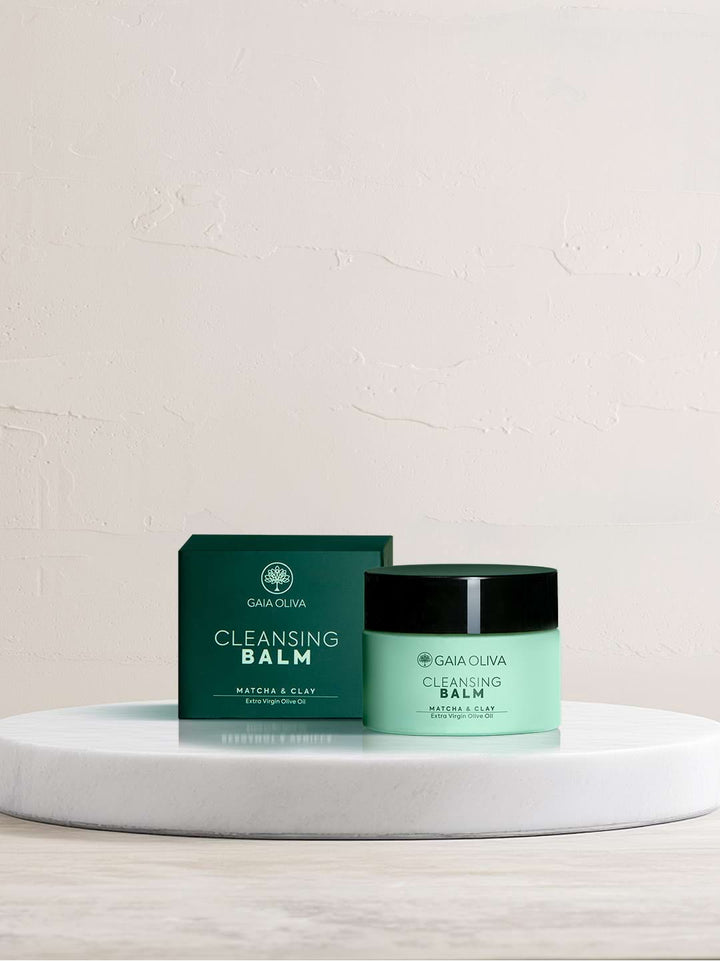a jar of olive oil cleansing balm on marble surface